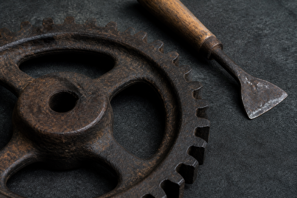 Iron gear and wood-handled tool — conceptual history illustration