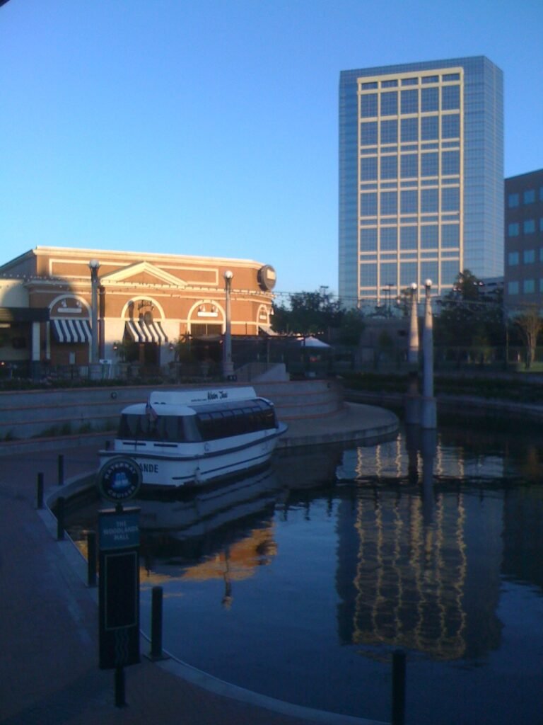 Archival Waterway view with a water taxi and surrounding buildings