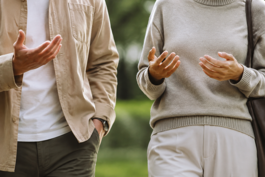 Two adults talking during a relaxed walk — conceptual image