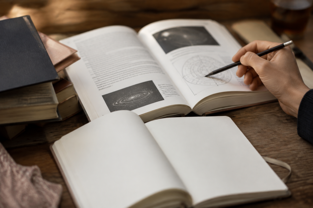 Reader taking notes beside a reference book — conceptual image