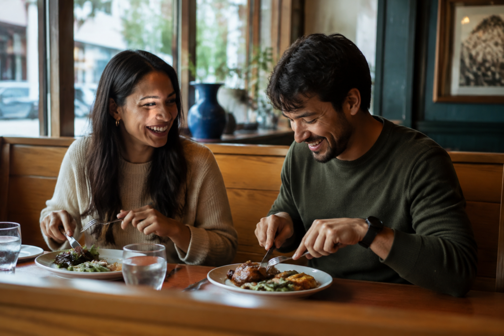 Couple enjoying an early dinner at a cozy neighborhood restaurant booth
